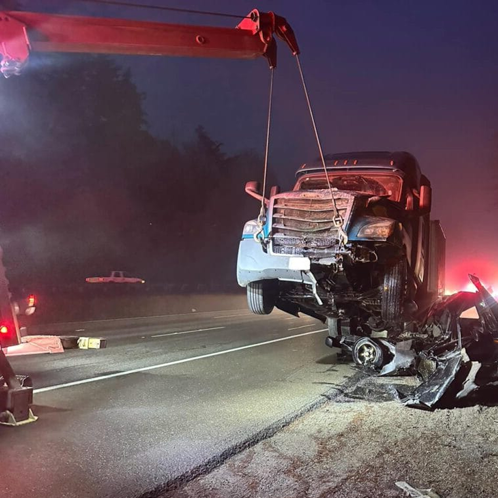 photo shows Dynamic Truck & Trailer Repair & Towing wrecker towing a semi truck from an accident crash