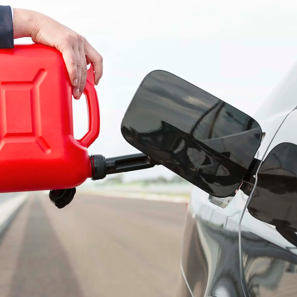 photo shows Dynamic Truck & Trailer Repair & Towing tech putting fuel in a vehicle 