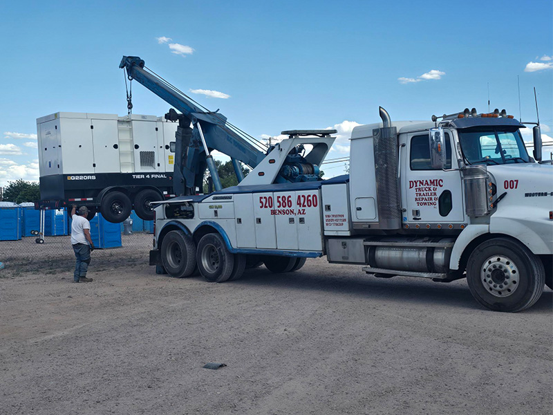 photo shows Dynamic Truck & Trailer Repair & Towing wrecker towing a semi truck