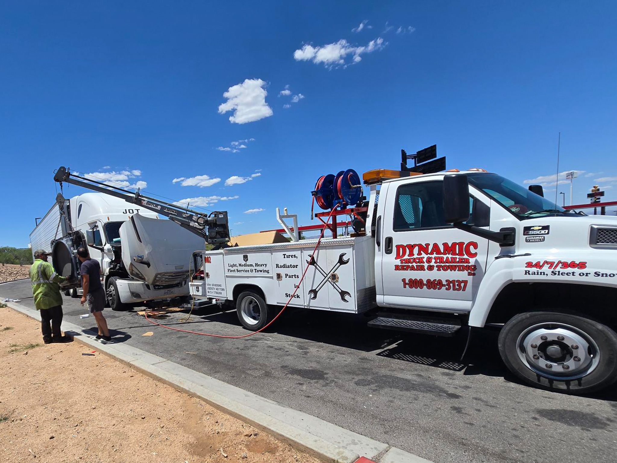 photo shows 2 Dynamic Truck & Trailer Repair & Towing wreckers recovering a flat bed trailer